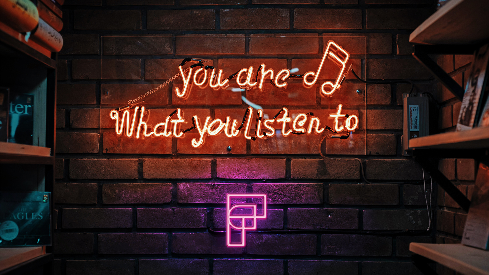 neon sign script "you are what you listen to"